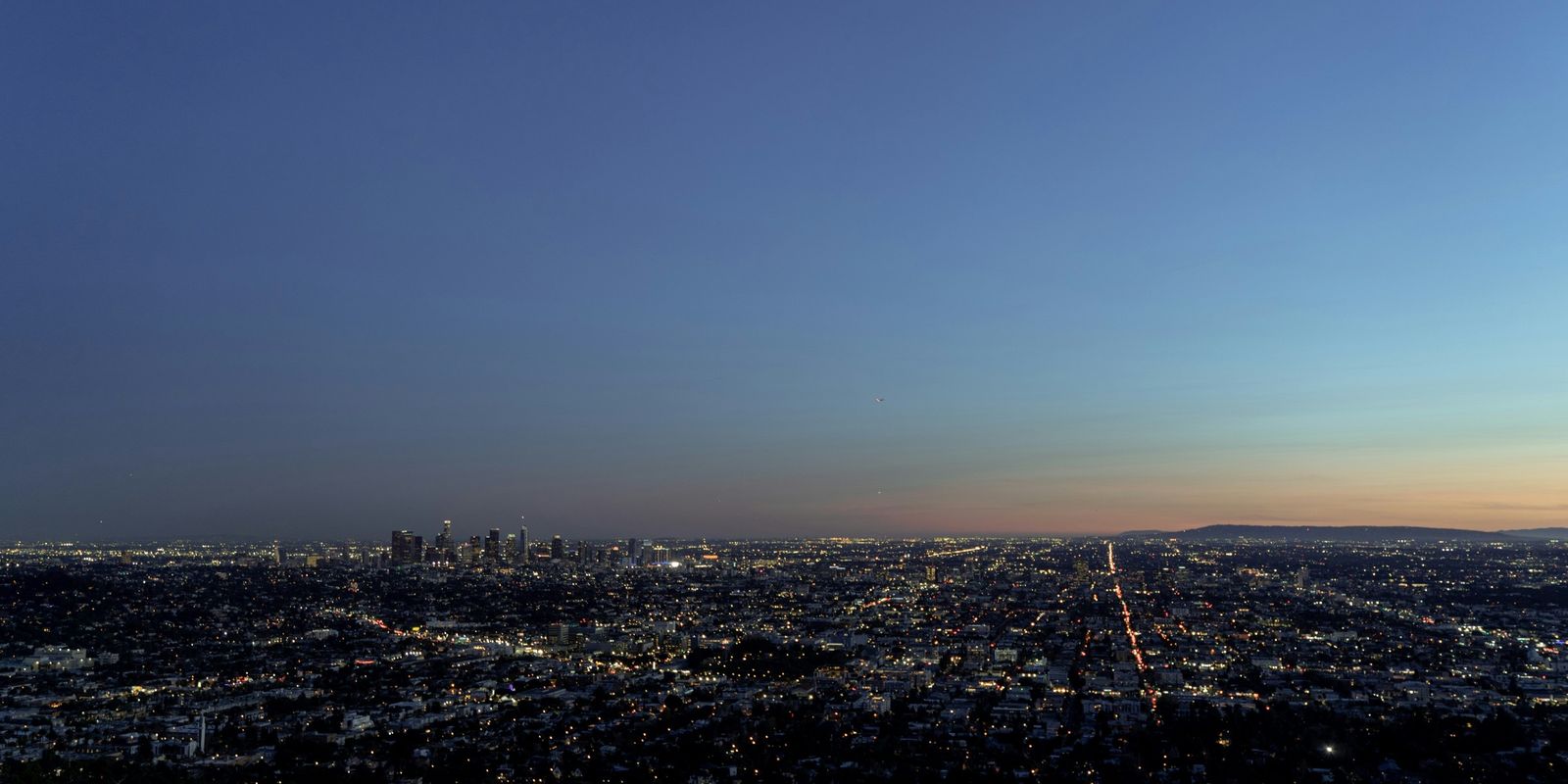 The Los Angeles basin at dusk, city lights spreading to the horizon