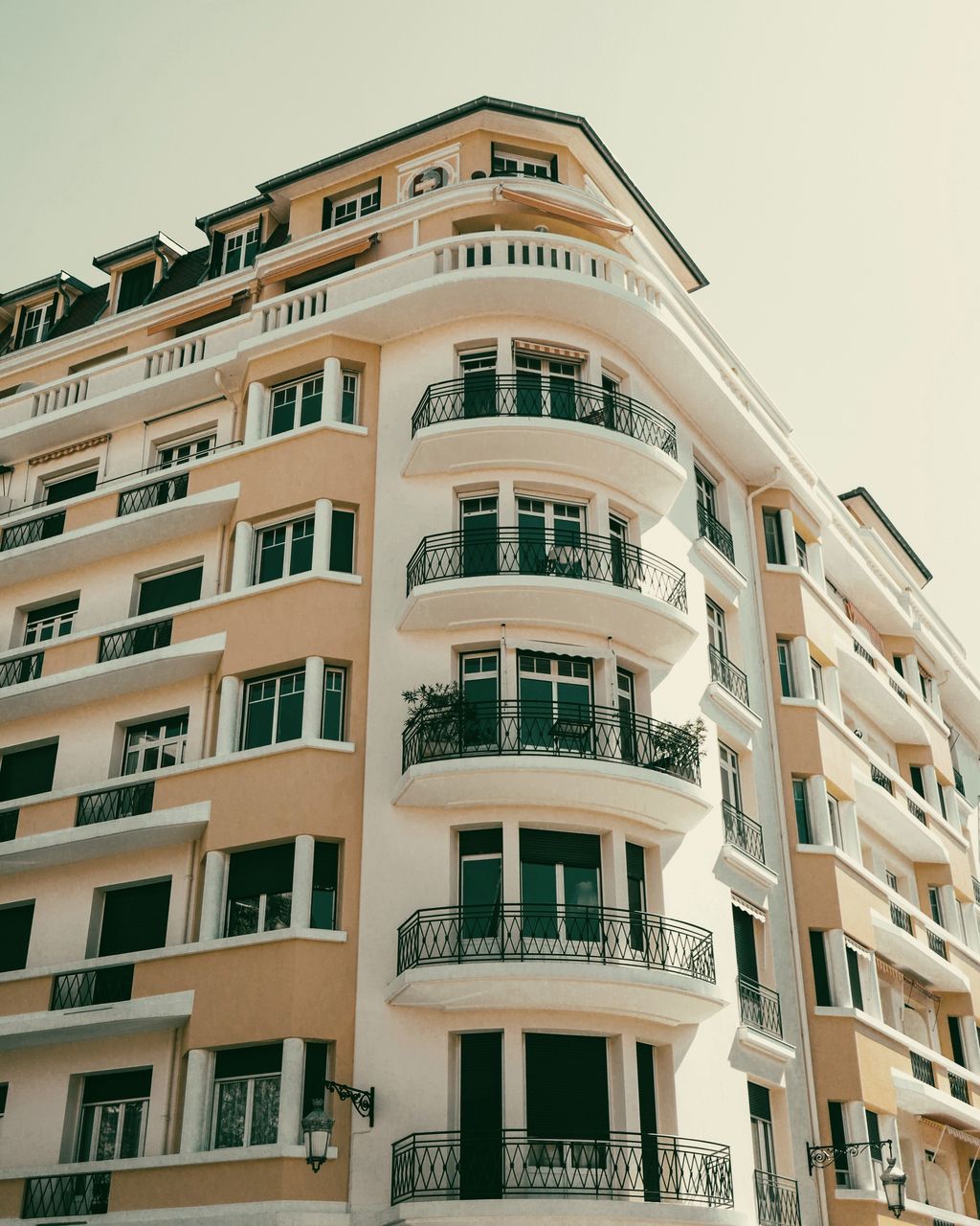 A classic residential building with curved balconies and wrought-iron railings