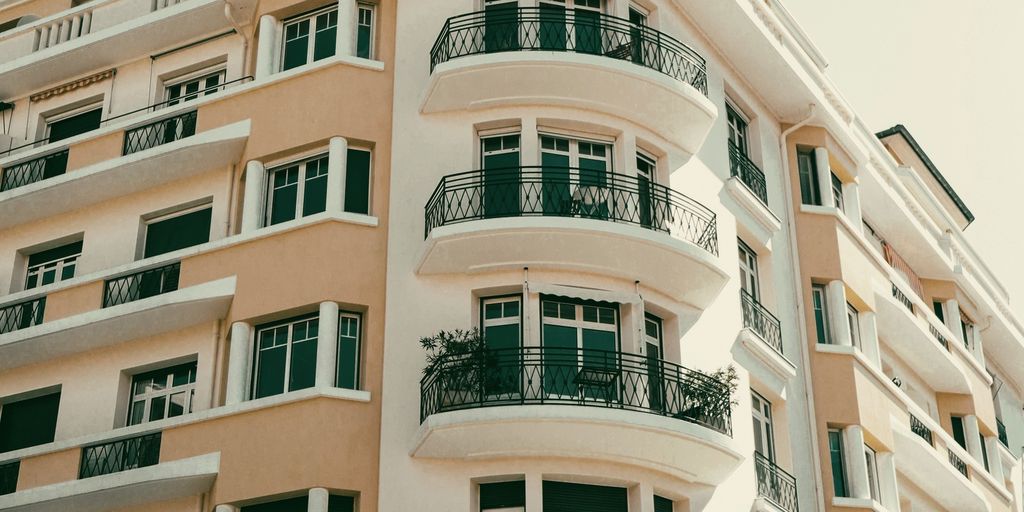 A classic residential building with curved balconies and wrought-iron railings
