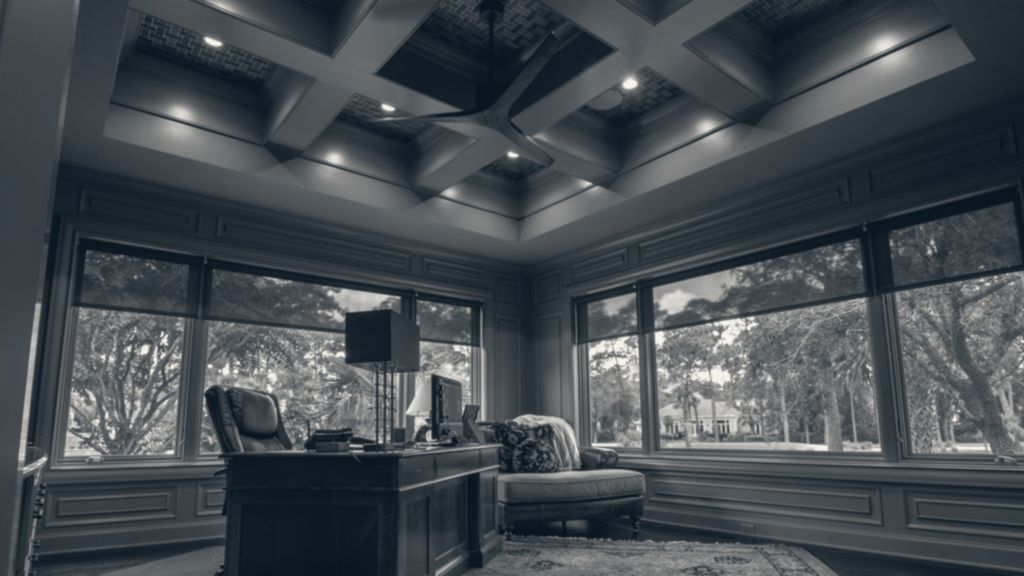 A paneled executive office with tall windows